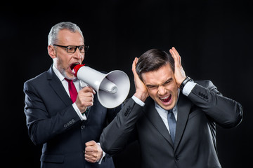 Naklejka premium Mature businessman with loudspeaker