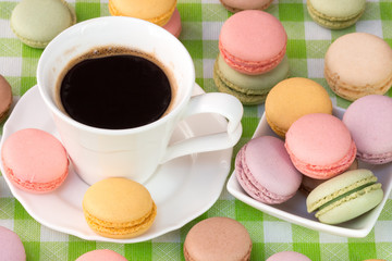 Macaroons with cup of black coffee