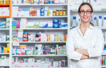 
Cheerful pharmacist chemist woman standing in pharmacy drugstore