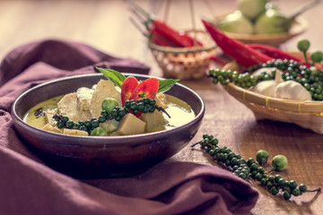 Chicken mussaman curry in bowl vegetables on wooden background