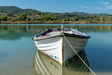 Naklejka na ściany i meble Old fishing boat on the lake