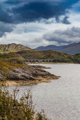 Old viaduct and loch in Scottish Highlands