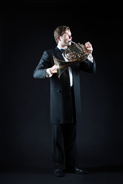 French horn player with music instrument