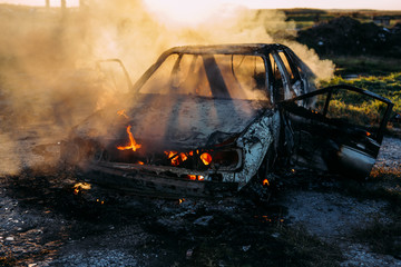 Smoke coming out from burnt out car