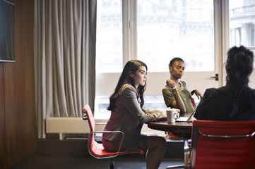 Multi ethnic business colleagues in an office meeting