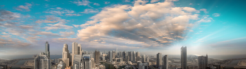 Fototapeta premium Aerial panoramic view of Dubai Marina skyscrapers at sunset