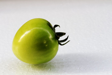 Green tomato on white background.