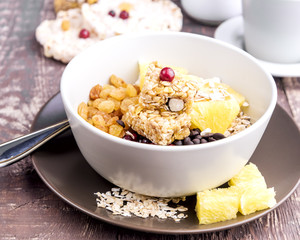 Breakfast bowl with Muesli Oat flakes Berry Raisins and orange