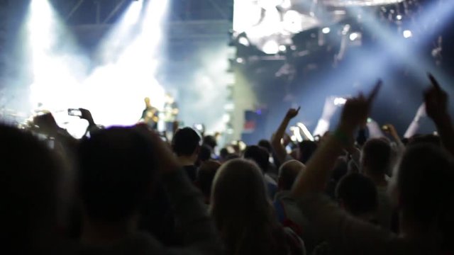 People partying at rock concert, slow-motion