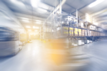 blurred warehouse interior wirh moving forklift