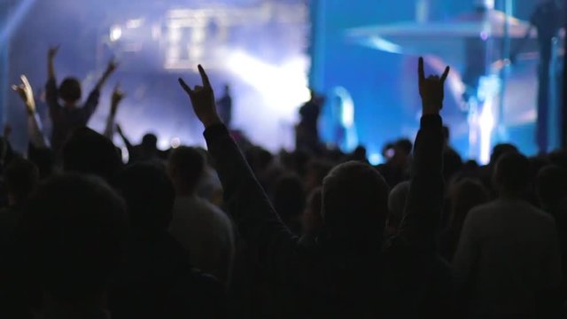 People partying at live music concert, slow-motion