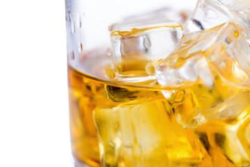 Glass of scotch whiskey and ice on a white background.