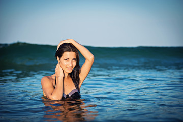 Beautiful girl is posing in the sea