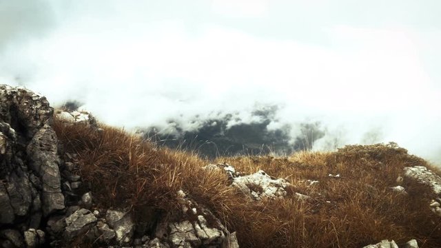 motion along the rocky terrain in autumn misty mountains