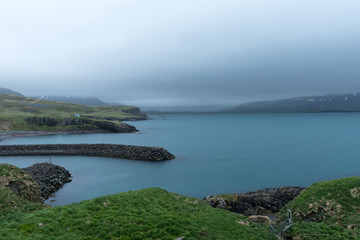 Harbor inlet with dark clouds iceland