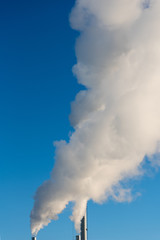 White smoke in blue sky.