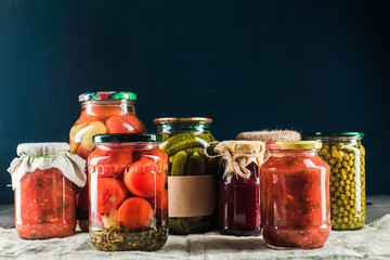 Preserved vegetables on wooden background