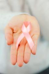 female hands holding AIDS awareness ribbon