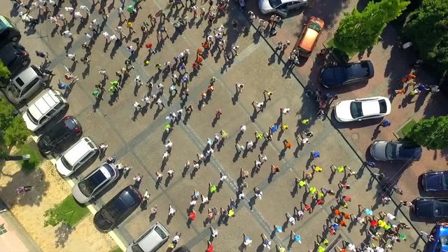 Aerial footage. Vertical rotate camera. Marathon on streets.