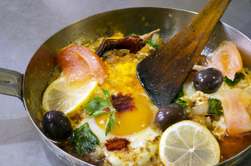 fried eggs with onions, celery, olives, pickled tomatoes