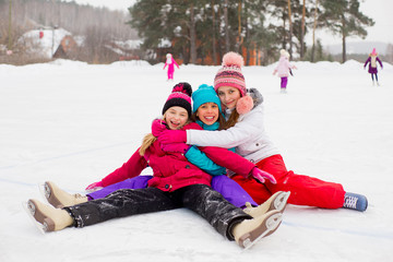 Fototapeta premium three attractive skater girl sitting on the ice