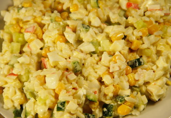 Salad with crab sticks, corn, cucumber, eggs and rice