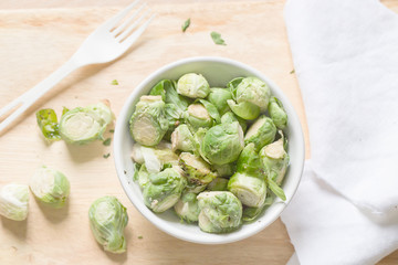 a white bowl of brussells sprouts
