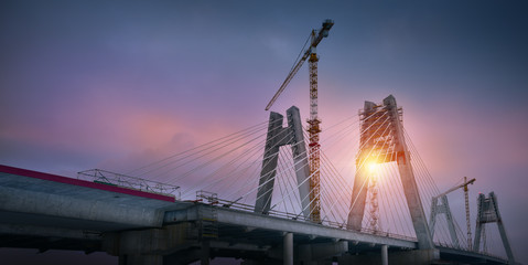 Cranes on the bridge at sunrise. Cracow Poland
