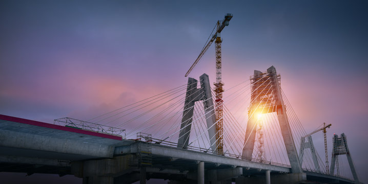 Fototapeta Cranes on the bridge at sunrise. Cracow Poland