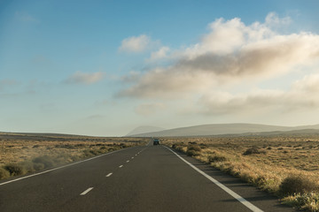 Fototapeta na wymiar landscape with highway to mountains on Lanzarotte