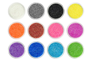 Set of twelve different colors glitter particles in open containers, view from above. Can be used...