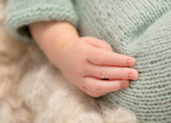 Fototapeta na wymiar lovely little hand of newborn baby, closeup