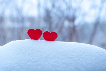 Fototapeta premium two beautiful hearts on a winter background