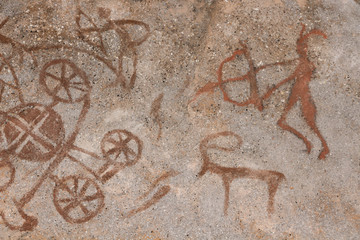 Drawing on a rock cave wall ocher paint, ancient prehistoric Neanderthal man. man surrounded by prehistoric animals, head of intelligence, radiance, lord