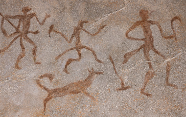 Drawing on a rock cave wall ocher paint, ancient prehistoric Neanderthal man. man surrounded by prehistoric animals, head of intelligence, radiance, lord