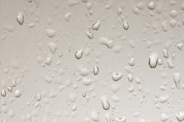 Water droplets on the vertical glass.