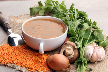 Lentil soup with pita bread in a bowl on a wooden background