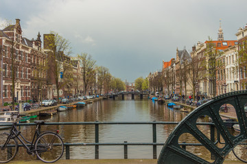 Fototapeta premium View from brigge with wheel to canal in Amsterdam, Netherlands