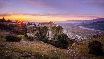 Breathtaking view of Meteora Agios Stefanos Monastery at sunrise, Greece. Geological formations of big rocks with Monasteries  on top of them. Can see the valey of Thessaly and the city of Kalampaka.
