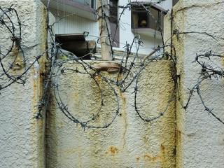Grungy urban wall texture with barbed wire security