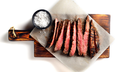 grilled beef on a board on a white background