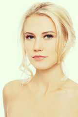 Fototapeta premium Vintage style portrait of young beautiful blond girl with clear make-up 