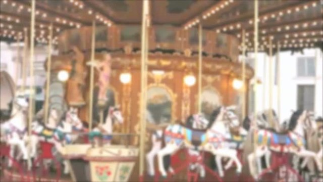 Blurry out of focus merry go round carousel