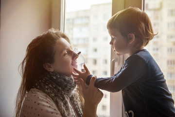 Sick girl makes inhalation with a mask on his face