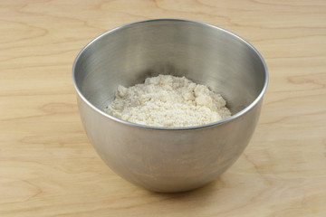 Packaged dry cookie or cake mix in stainless steel mixing bowl