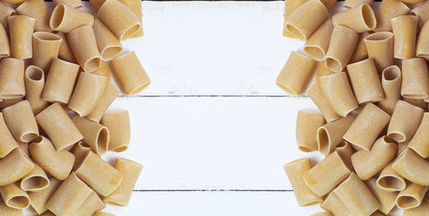 composition of raw Paccheri Pasta. Variety of Italian pasta in the shape of a very large tube. 