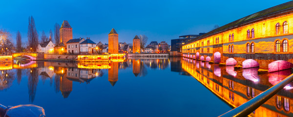 Panorama of medieval towers, bridges Ponts Couverts and Barrage Vauban with mirror reflections in Petite France during twilight blue hour, Strasbourg, Alsace, France - obrazy, fototapety, plakaty