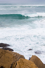Fototapeta na wymiar atlantic coastline with surfes in cloudy day