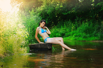 Fototapeta premium Yong happy girl relaxing in the forest river