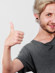 Content young man giving thumb up